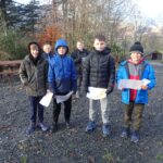 pupils posing for the camera and wearing outdoor clothing and woolly hats